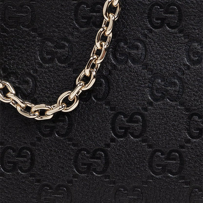 Gucci GG Leather Shoulder BagBagsGucciDPUS Designer Outlet815277-10008137462274BlackClose-up of Gucci GG embossed black leather shoulder bag with repeating monogram pattern and gold-tone chain.