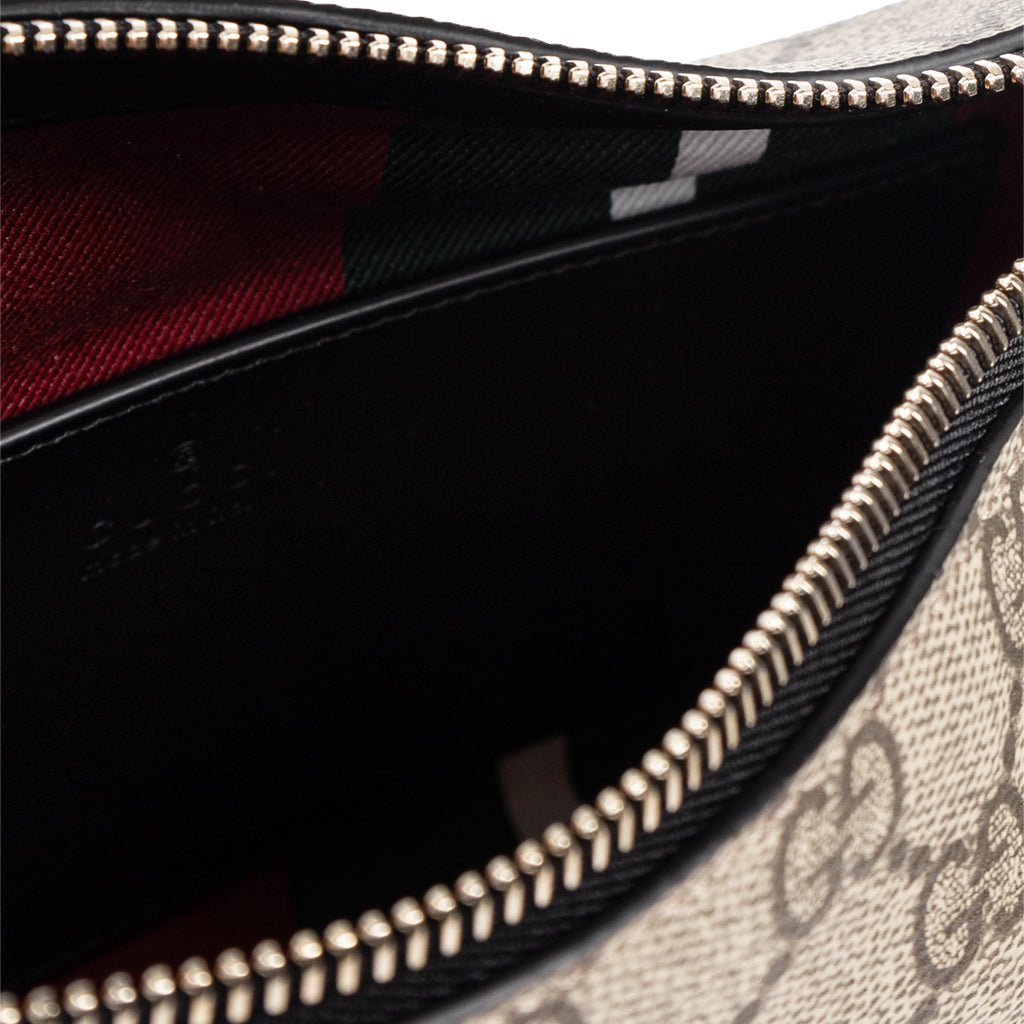 Gucci GG Monogram Shoulder BagBagsGucciDPUS Designer Outlet815218-97658137135656BlackInterior close-up of Gucci GG Supreme canvas shoulder bag with black leather trim, gold zipper and striped lining.