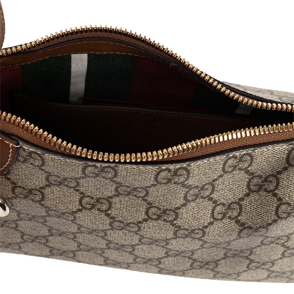 Gucci GG Monogram Shoulder BagBagsGucciDPUS Designer Outlet8152188137033543BrownInterior close-up of Gucci GG Supreme canvas shoulder bag with brown leather trim, gold zipper and striped lining.