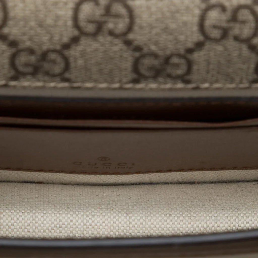 Gucci GG Supreme Monogram Crossbody Shoulder BagBagsGucciDPUS Designer Outlet671620-85638101485227BrownInterior close-up of Gucci GG Supreme canvas crossbody bag showing light beige lining and embossed Gucci logo.