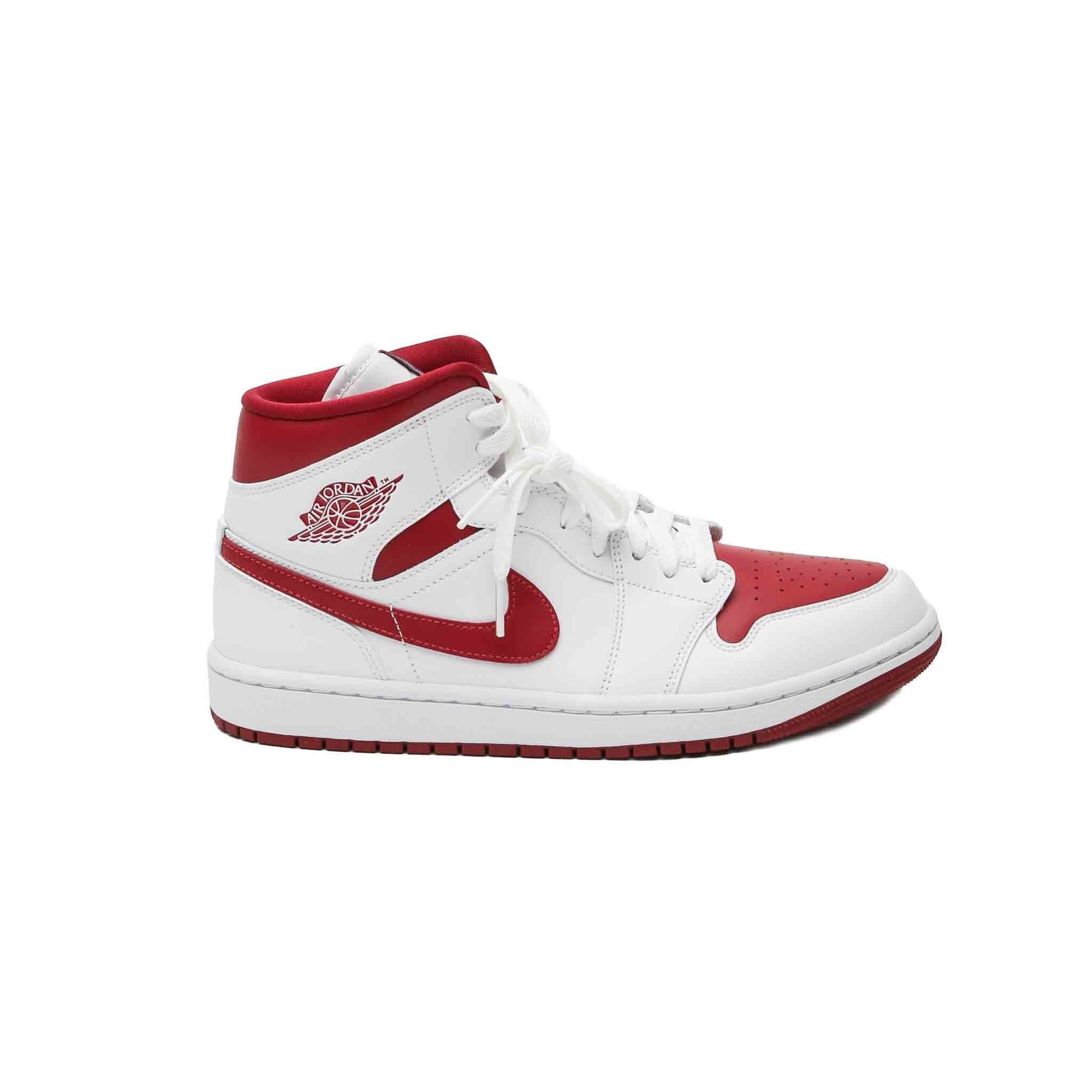 Nike Air Jordan 1 Mid Womans Reverse ChicagoSneakersNikeDPUS907719435.5The Nike Air Jordan 1 Mid is a stylish, high - performance sneaker that is perfect for casual wear. The white and red leather give this shoe a classic, sporty look, while the rubber sole provides traction and durability. Whether paired with jeans or leggings, this sneaker is sure to become a go - to favourite for any woman.