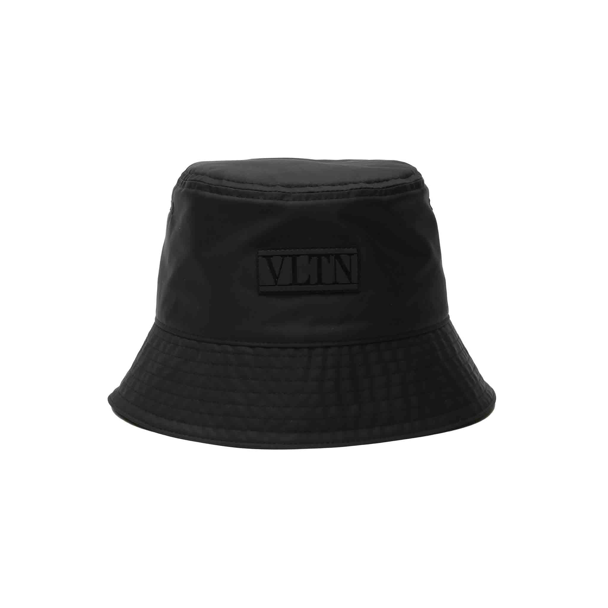 This stylish Valentino VLTN bucket hat is made of durable nylon and features a rubber VLTN logo on the front. It is available in sizes 58-59-60 and is made in Italy. This hat comes in a classic all black colour. It is perfect for any casual occasion.