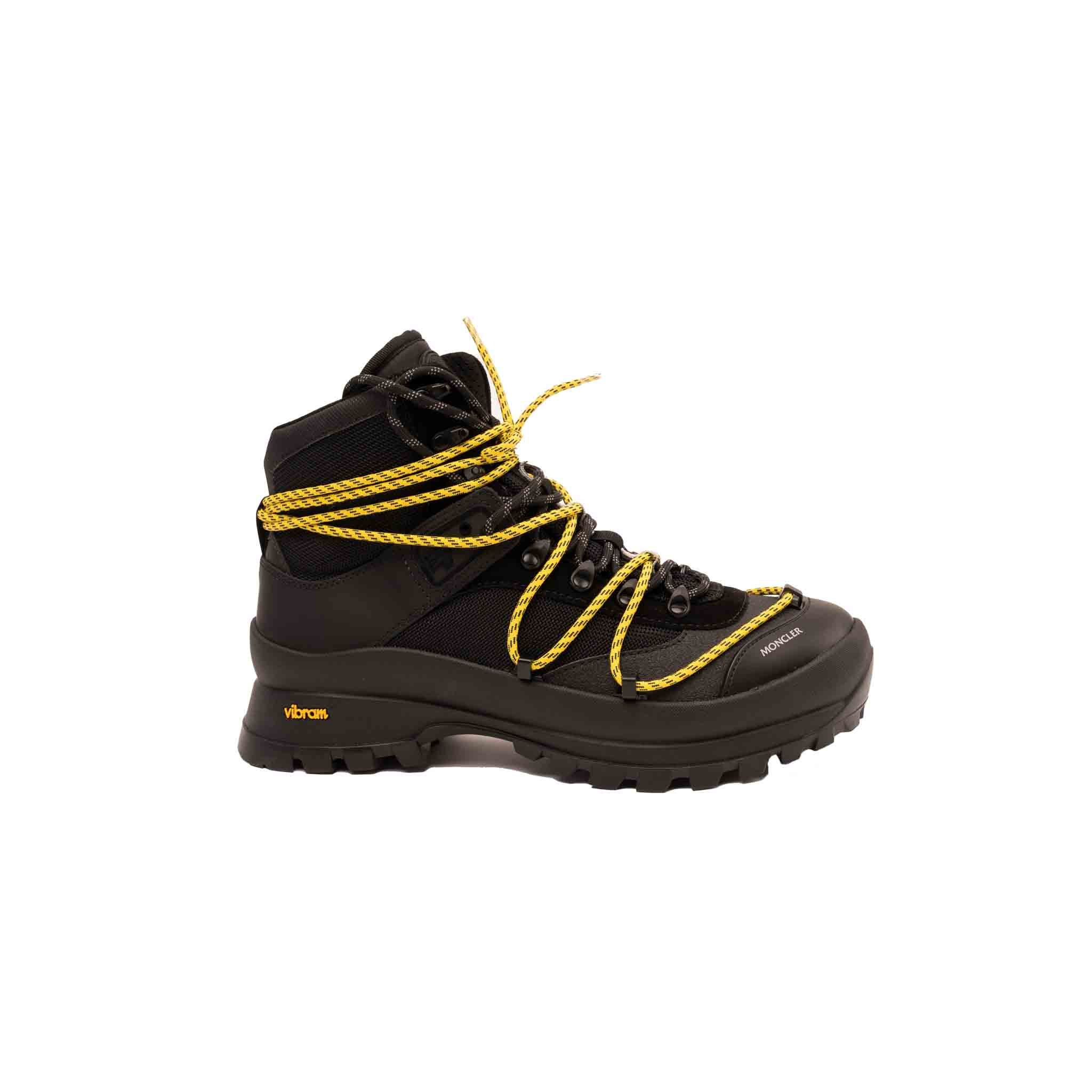 Ankle-high mesh boots in black. Tonal faux-suede and faux-leather trim throughout. Logo embossed in grey at round toe. Double lace-up closure in black and yellow. Rubberized logo patch and webbing daisy chain at padded tongue. Padded collar. Embossed logo at sides. Tonal treaded Vibram® rubber sole featuring yellow embossed logo at outer side
