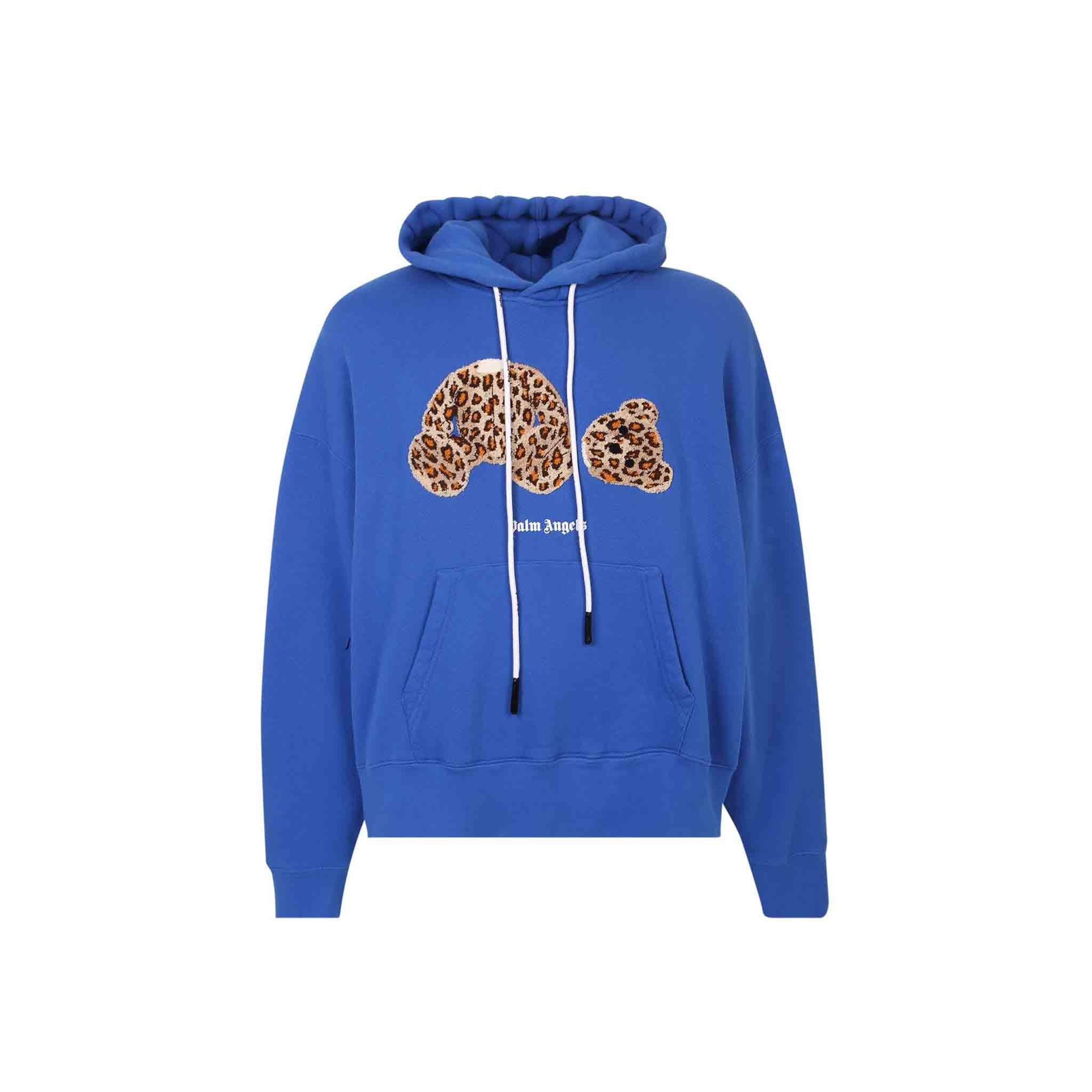 The Palm Angels Long Sleeve Hooded Sweatshirt is a stylish and comfortable choice for cool weather. The bear graphic at the front and sprayed Palm Angels logo underneath add a unique touch to this sweatshirt. The hooded design with logo drawstrings and kangaroo pocket provide added warmth and practicality. This sweatshirt has an oversize fit for a relaxed and comfortable wear. Made of 100% cotton, this sweatshirt is soft and durable.